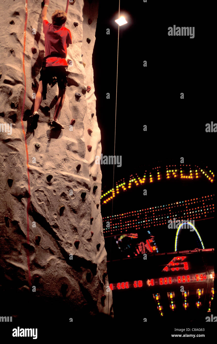 A man climbs on a climbing wall at the Nebraska State Fair in Grand Island, Nebraska, 2011 Stock