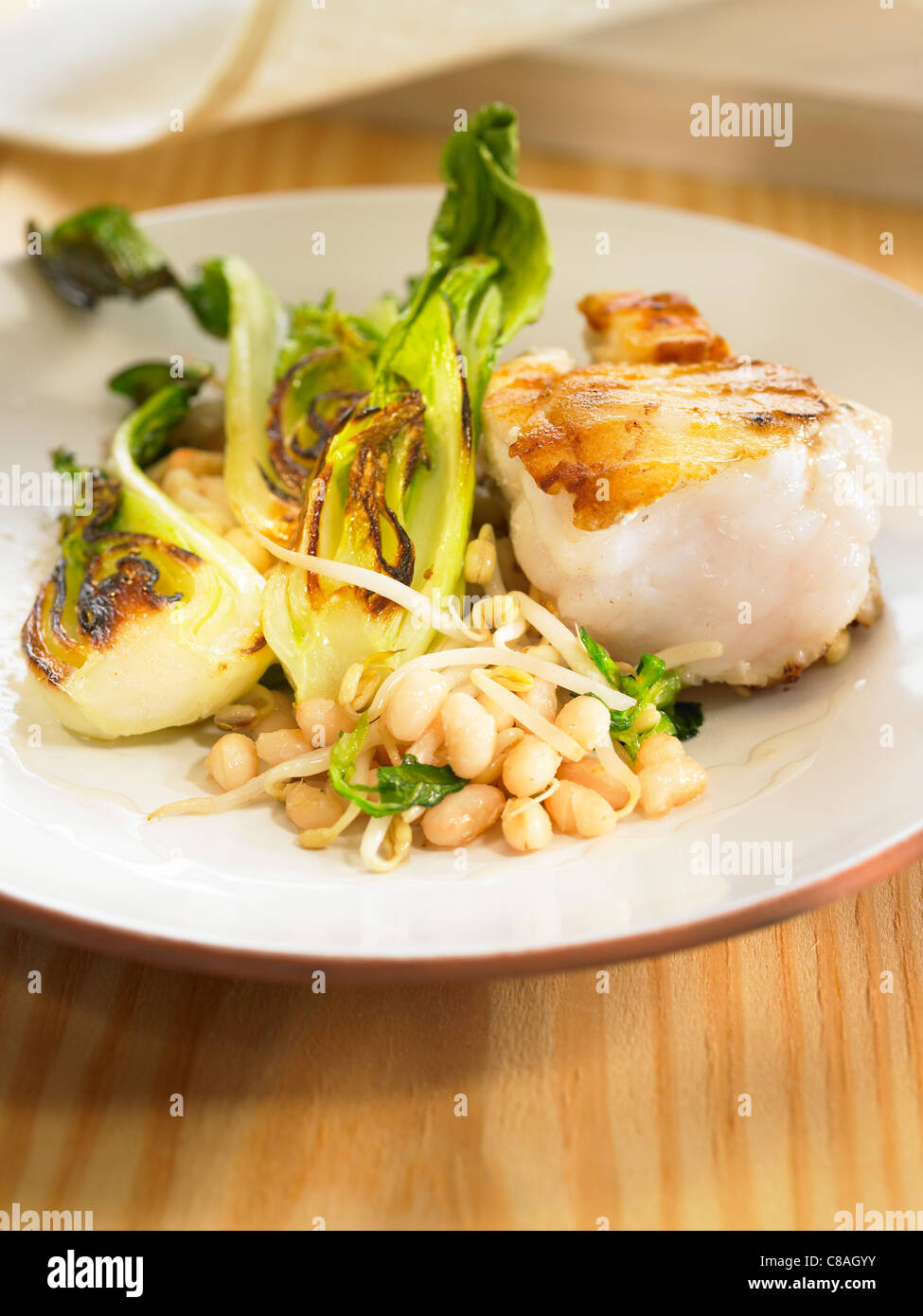 Monkfish with white beans,chinese cabbage and beansprouts Stock Photo