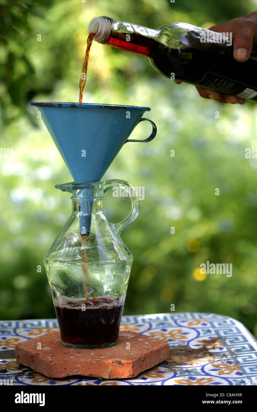 Filtering red wine vinegar Stock Photo Alamy
