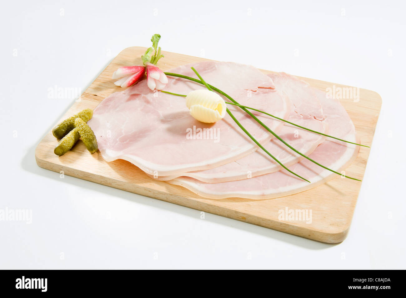 Sliced ham on a choppingboard Stock Photo