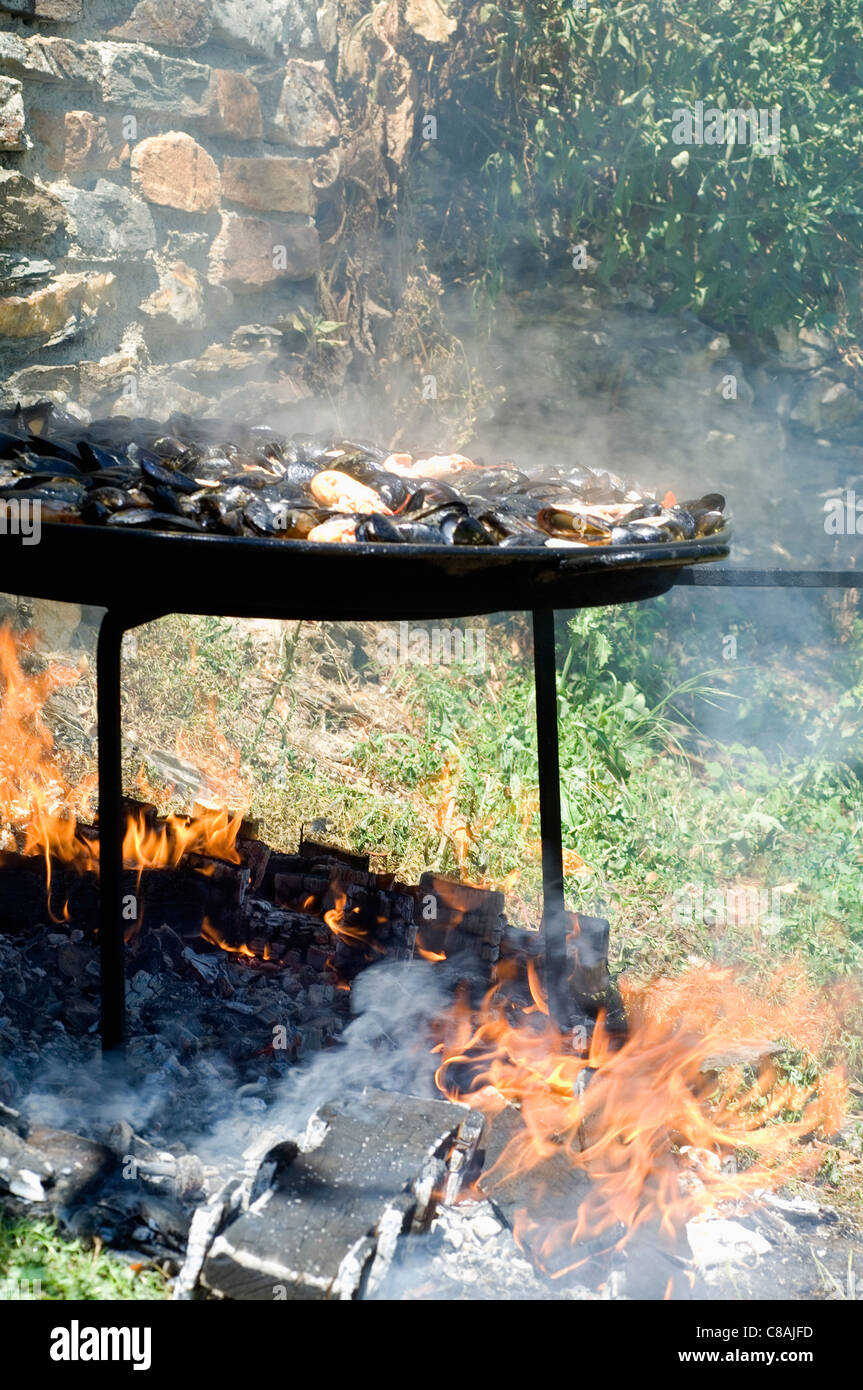 Cooking paella on an open fire Stock Photo