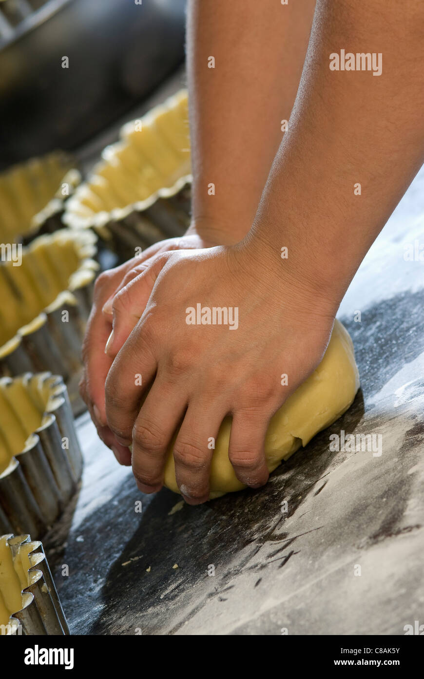 Person kneading pastry dough Stock Photo