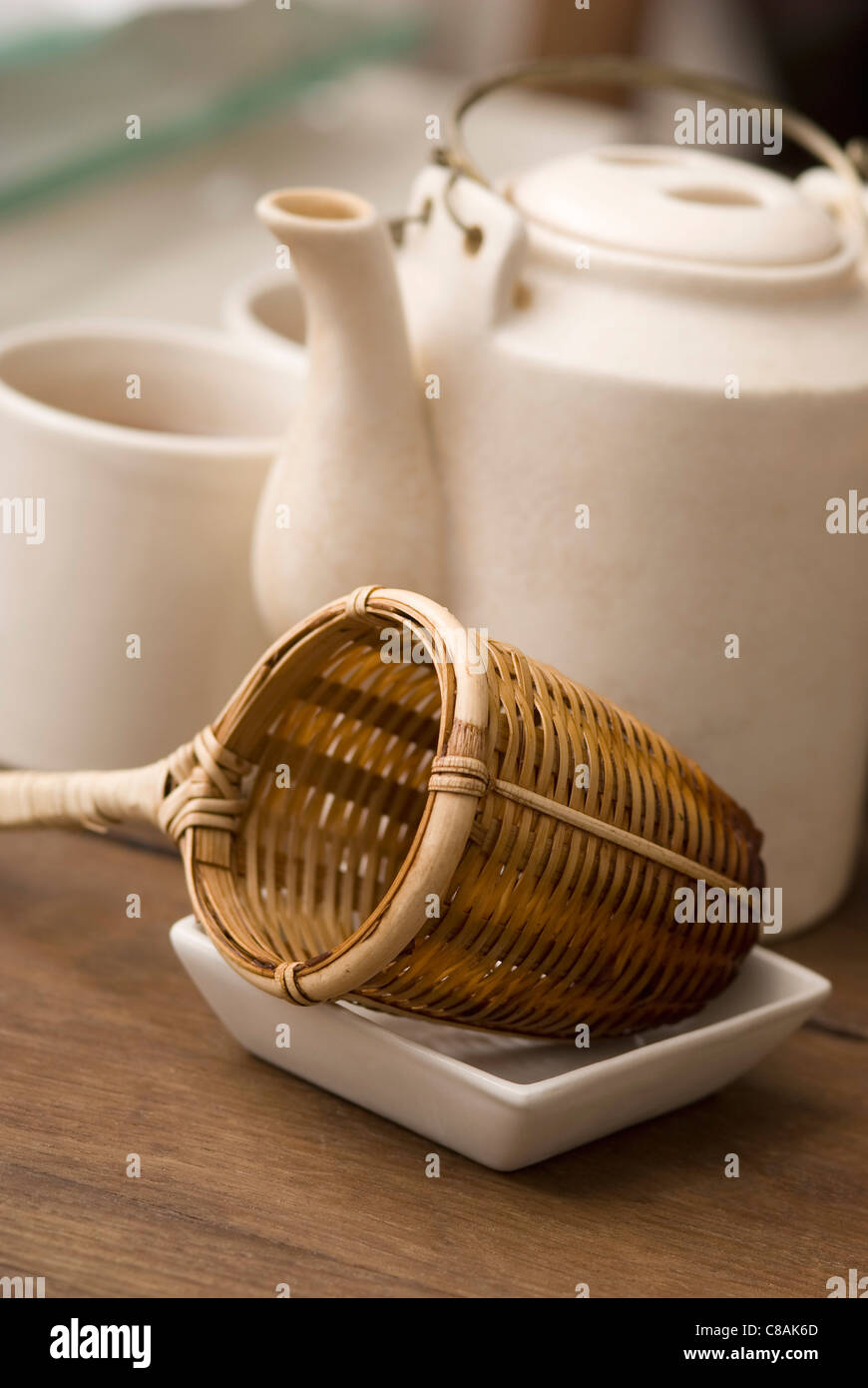Teapot,sieve and tea cups Stock Photo