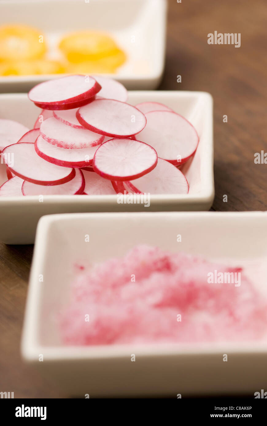 Dishes of sliced pink radishes Stock Photo