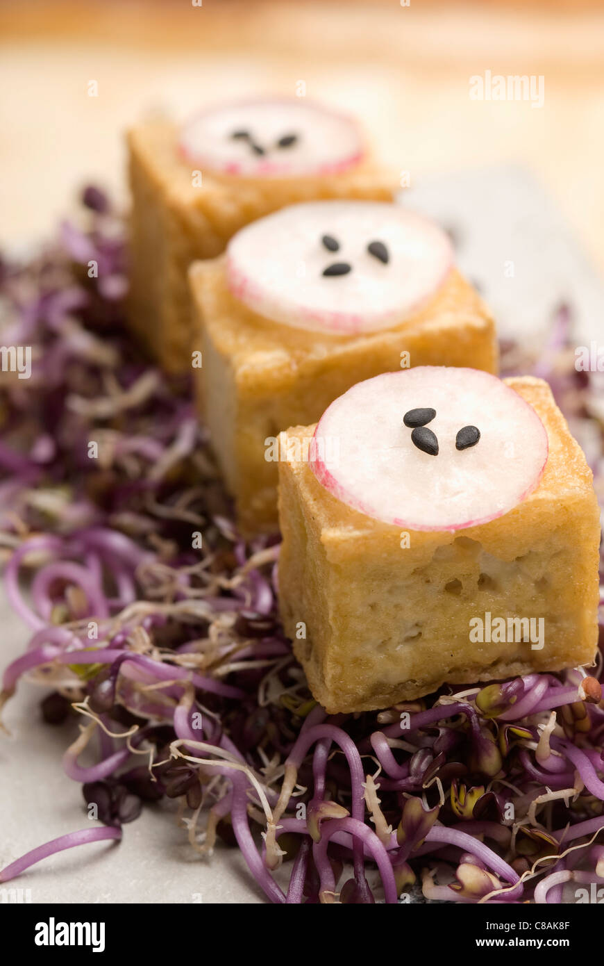 Fried tofu,pink radish and black sesame seed appetizers Stock Photo
