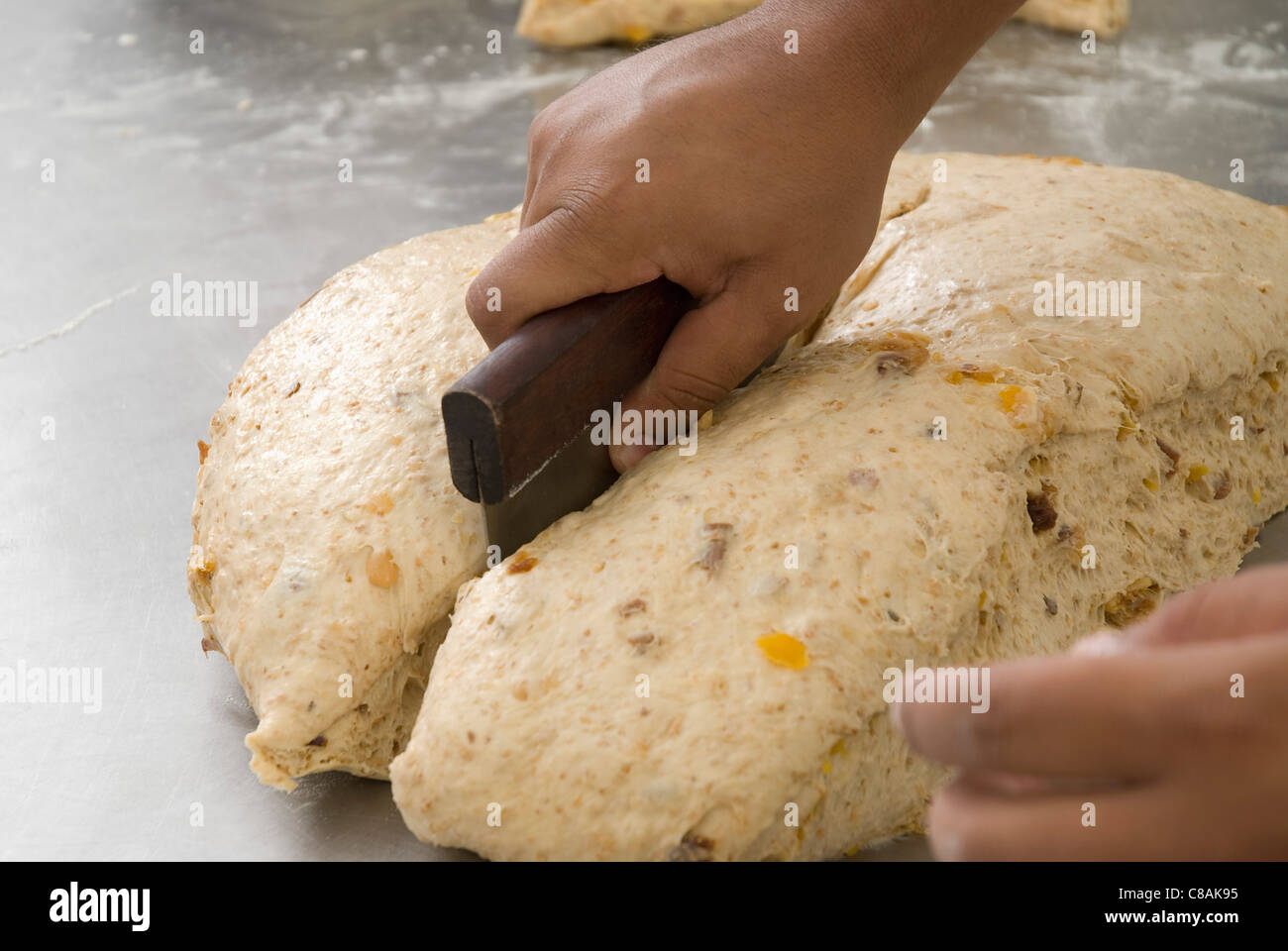 Cook dividing a dough ball Stock Photo