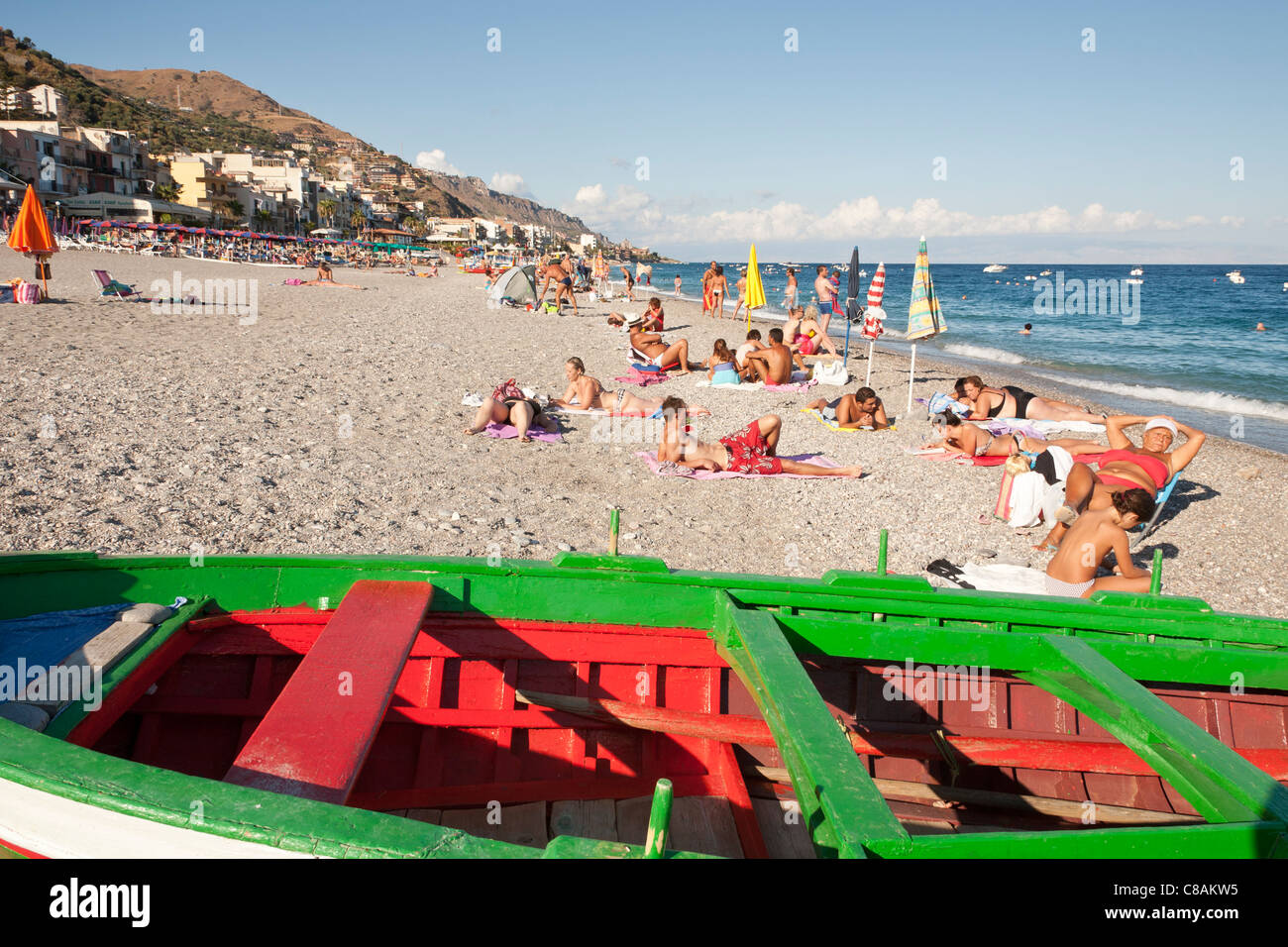 Tourists sunbathing, Letojanni Beach, Letojanni, Sicily, Italy Stock Photo