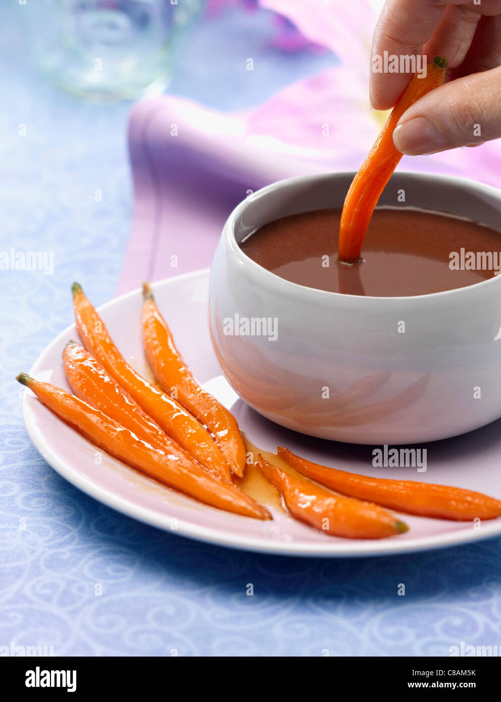 Mini carrots dipped in chocolate sauce Stock Photo