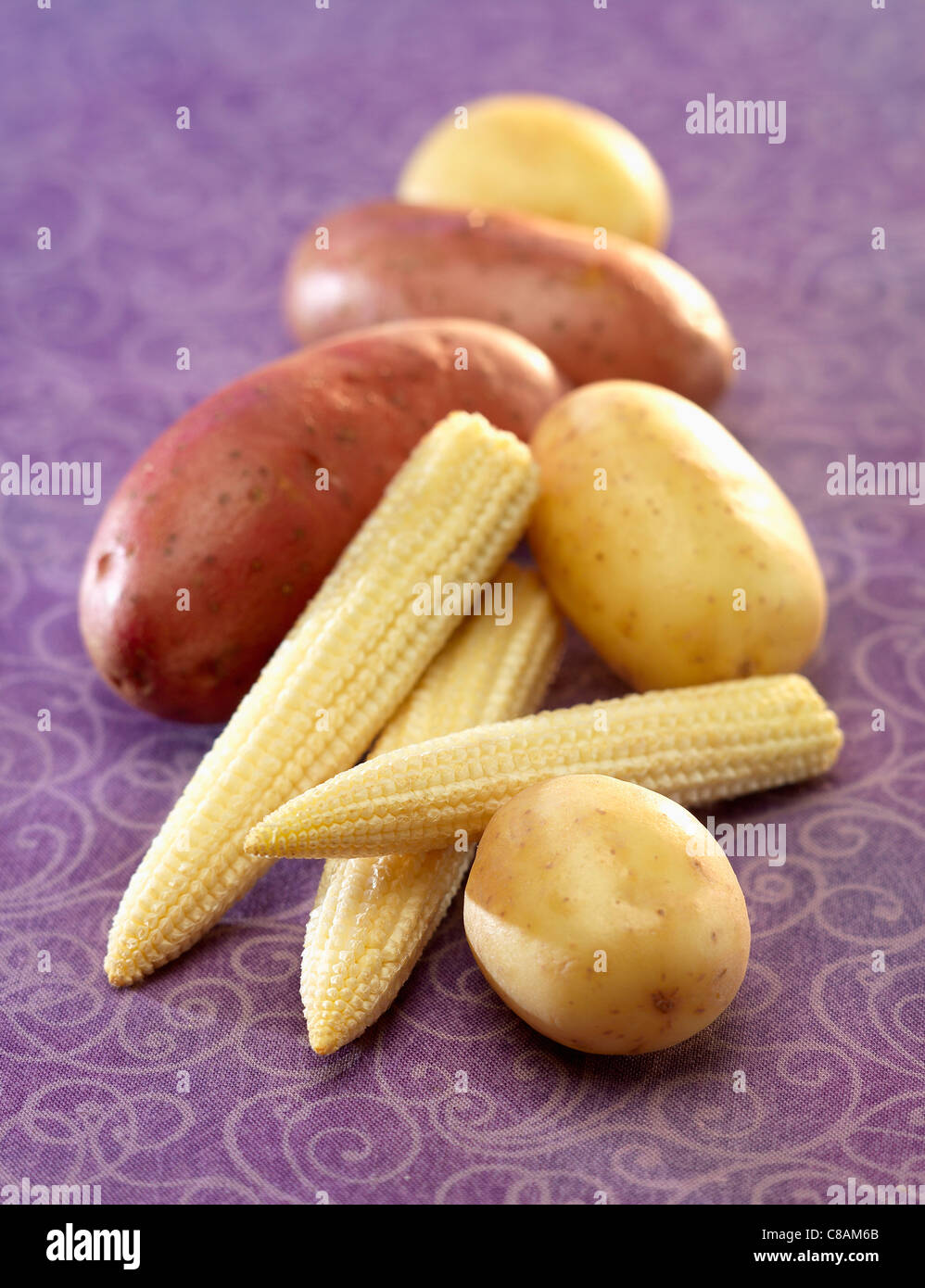 New potatoes and mini sweet corn on the cobs Stock Photo