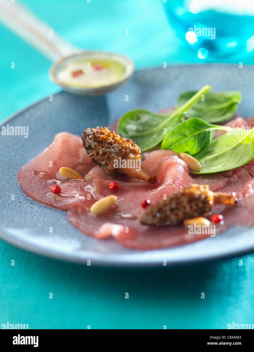 Red tuna Carpaccio with morels Stock Photo