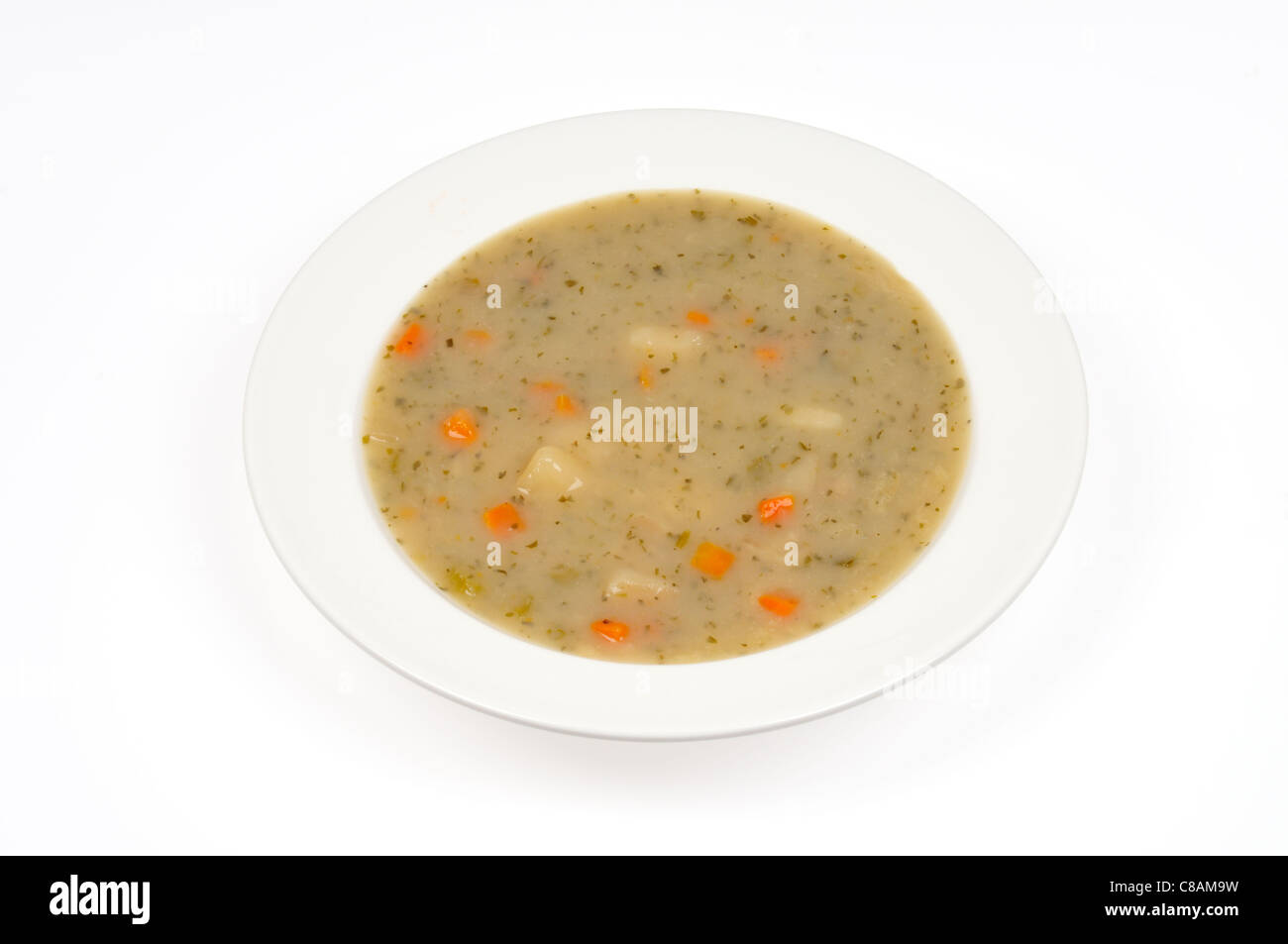 A bowl of potato and leek soup on white background cutout. Stock Photo