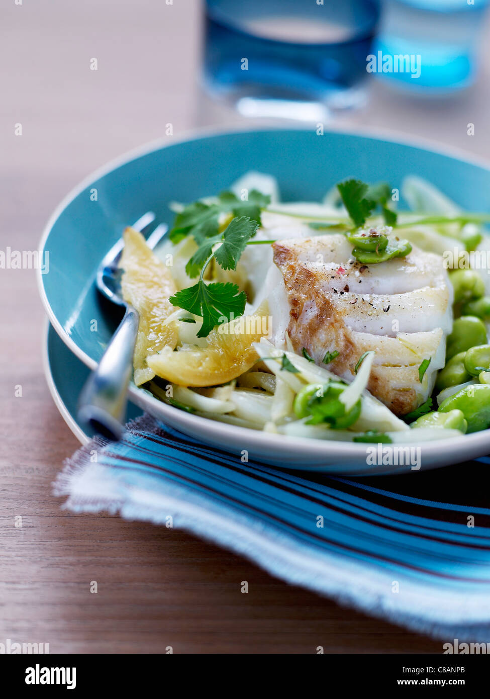 Pan-fried cod with broad beans and confit citrus Stock Photo - Alamy