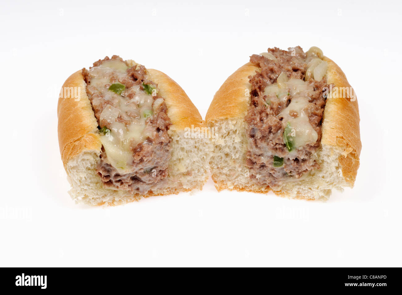 Philly cheesesteak cut in half on white background, cut out. Stock Photo