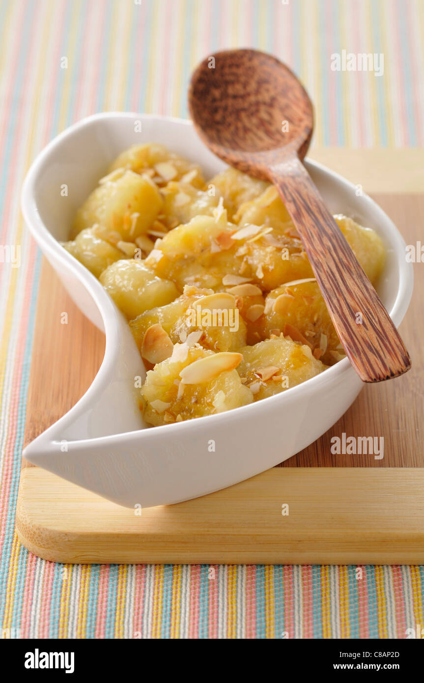 Stewed bananas with almonds and toffee sauce Stock Photo Alamy