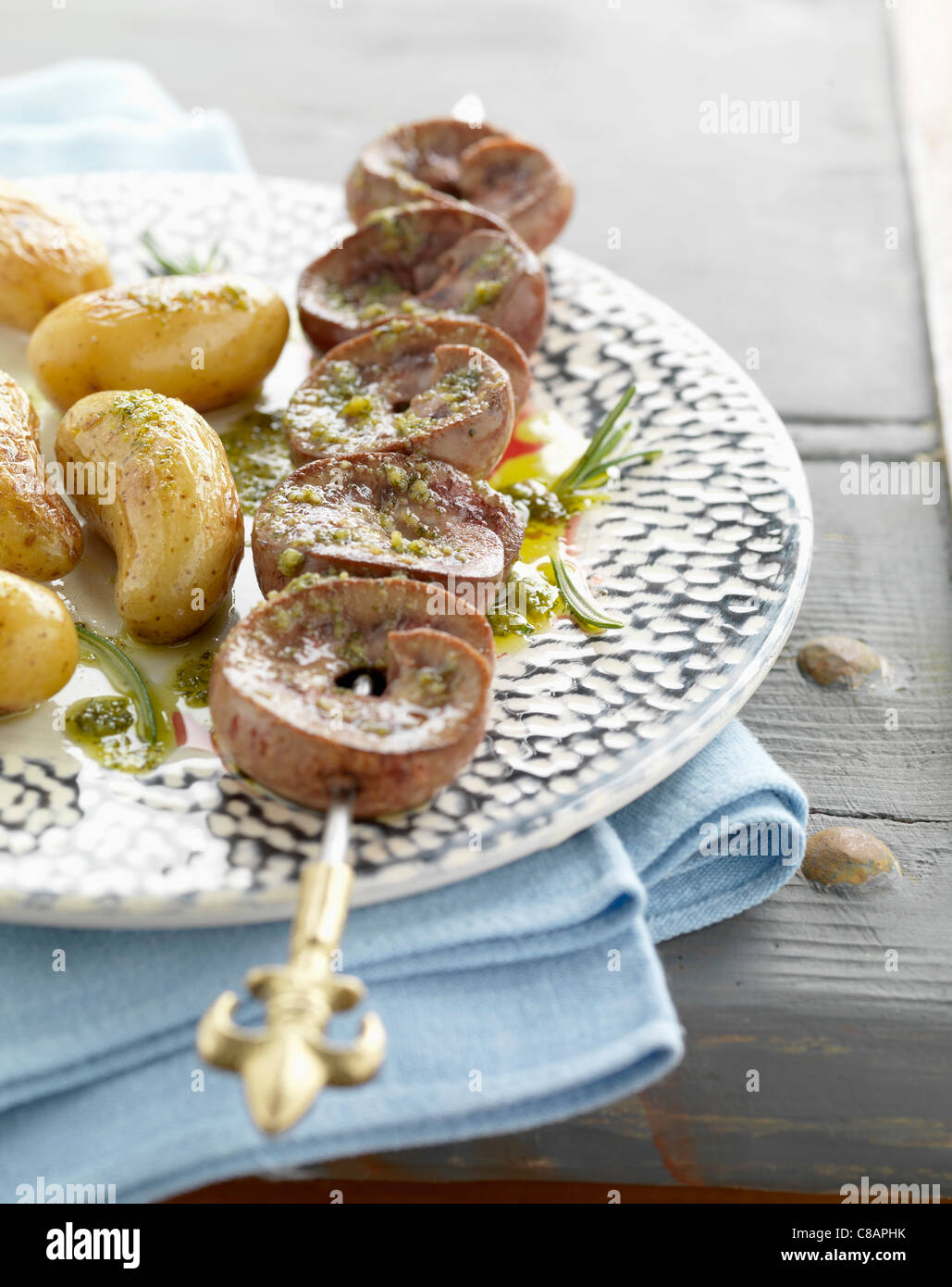 Kidney brochette with crushed garlic and parsley sauce Stock Photo Alamy