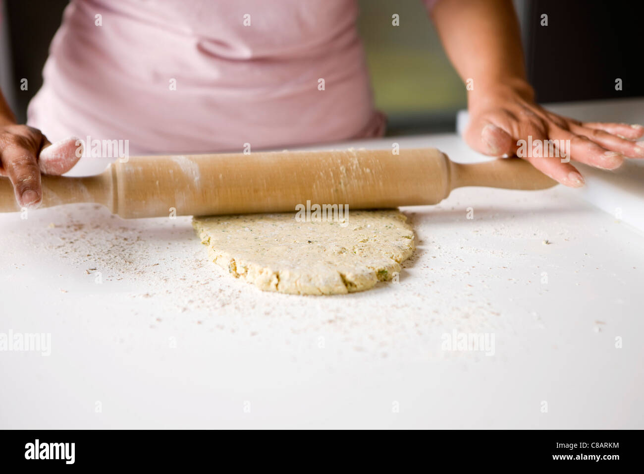 Flattening the soya bean mixture with a rolling pin Stock Photo