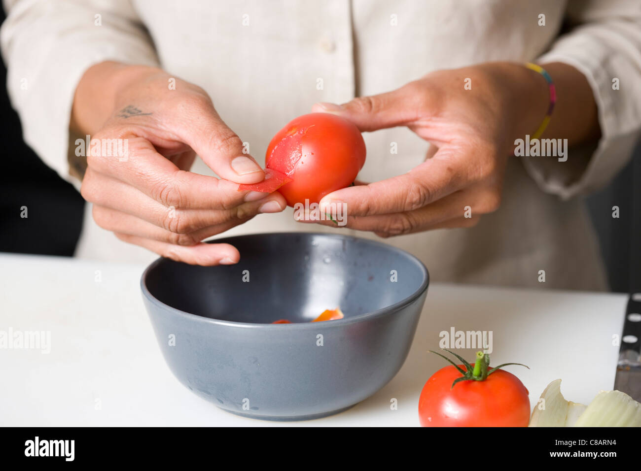 Peeling tomatoes Stock Photo