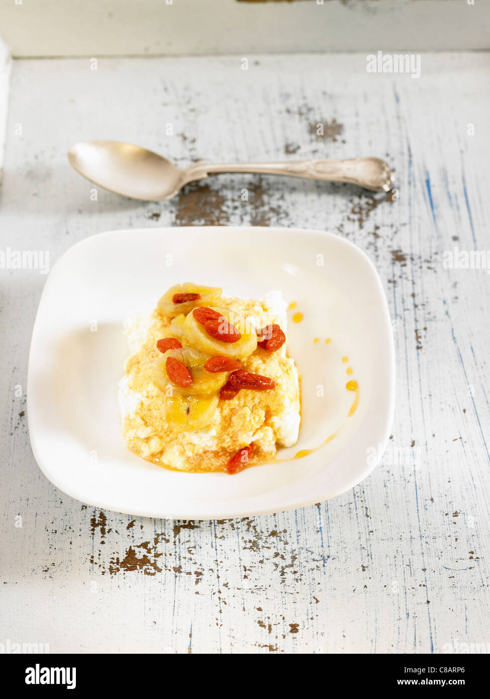 Cream cheese with stewed bananas and goji fruit Stock Photo Alamy