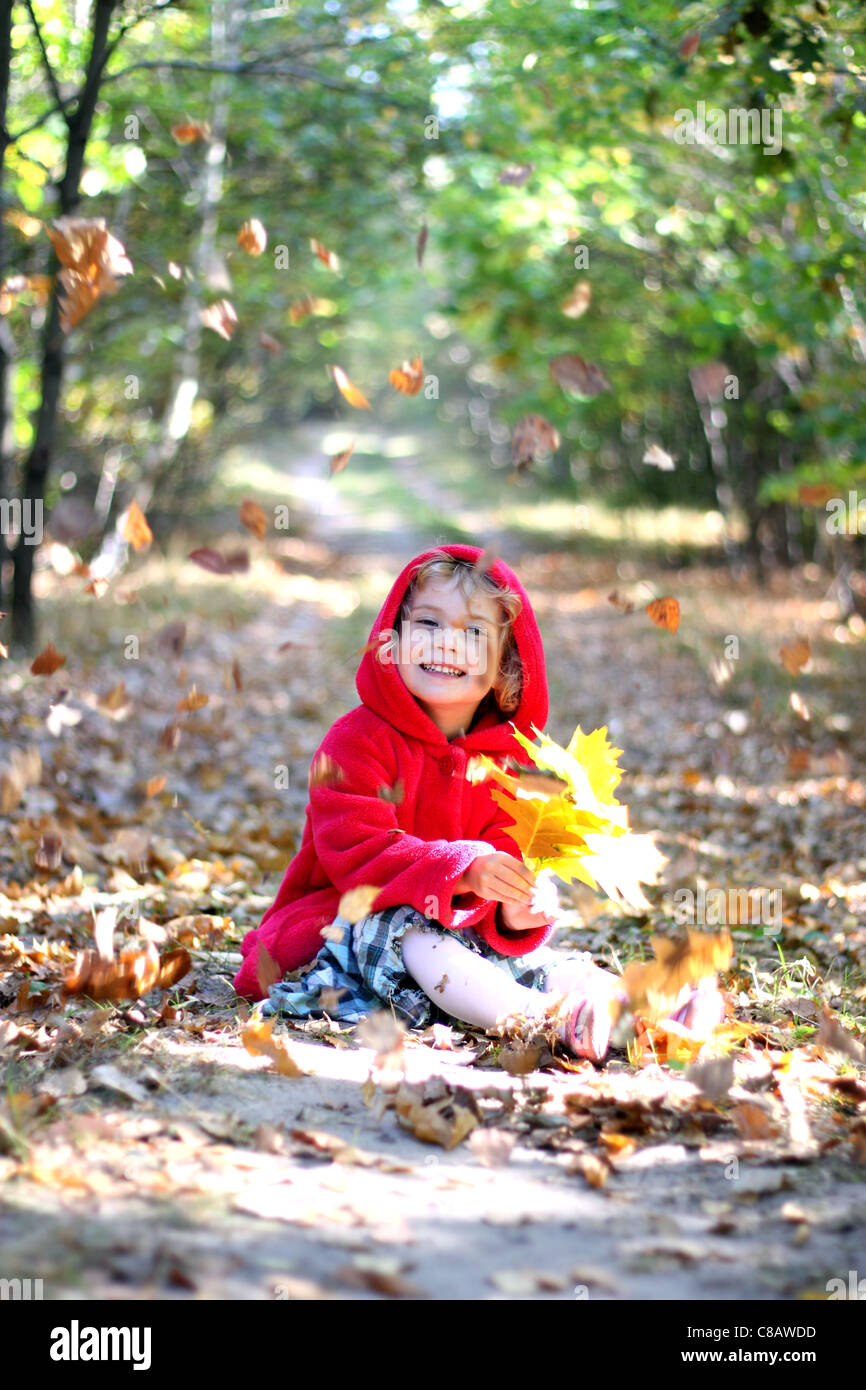 The little girl in a red cap in the autumn forest Stock Photo - Alamy