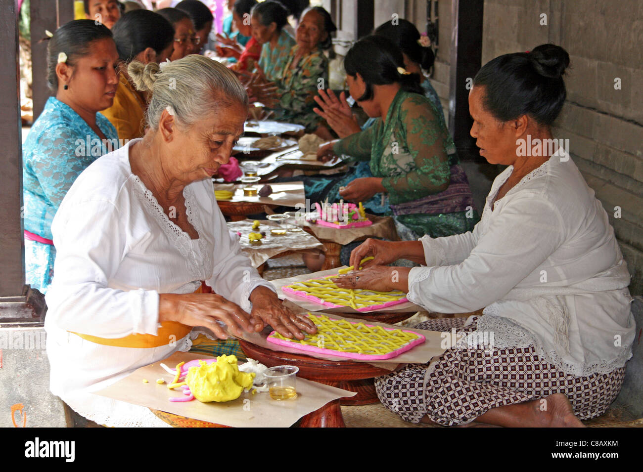 Balinese Ladies Preparing Decorative Temple Offerings Stock Photo