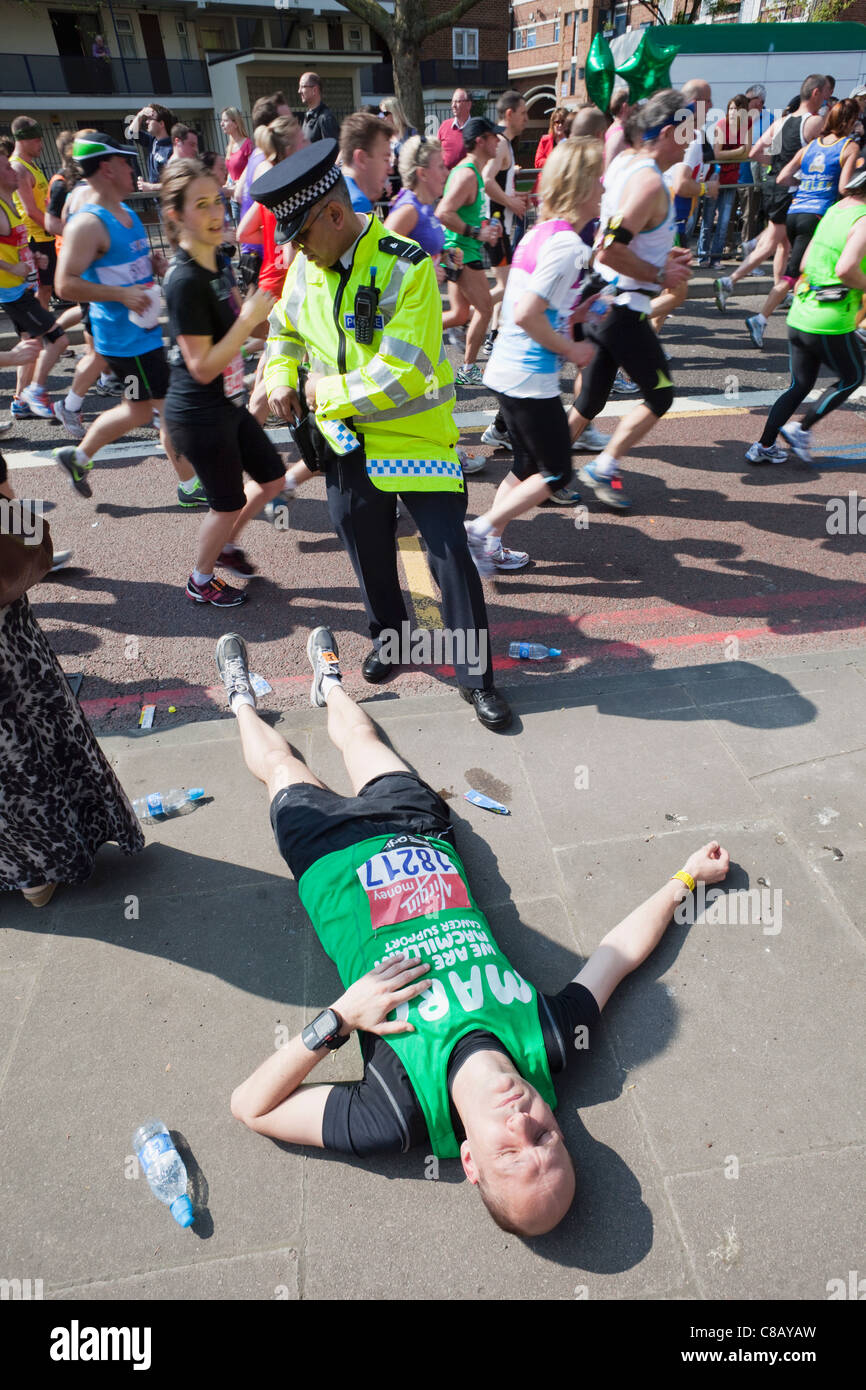 England, London, London Marathon, Fallen Runner Suffering from Cramp