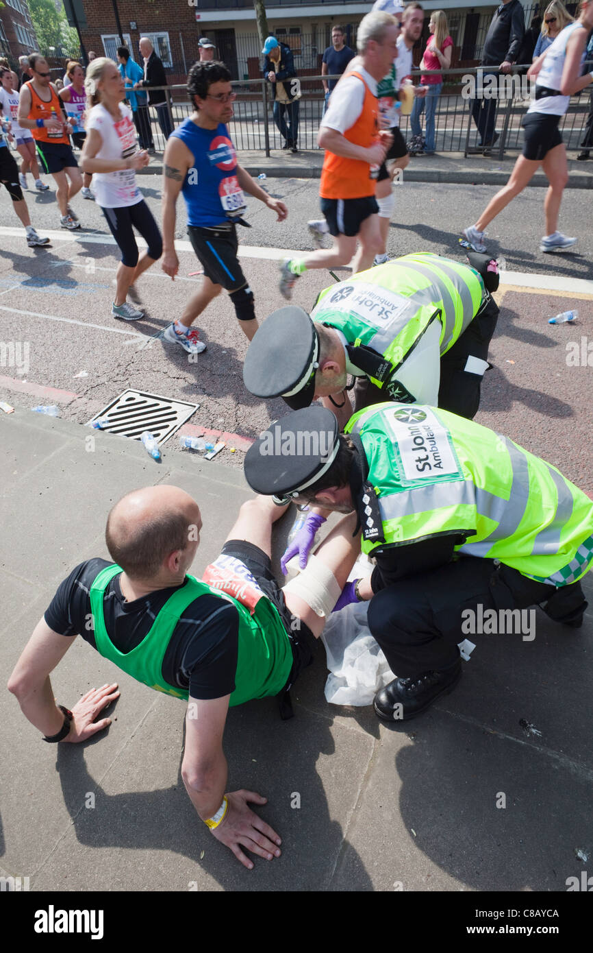 England, London, London Marathon, St.John Ambulance Staff Treating Injured Runners Stock Photo