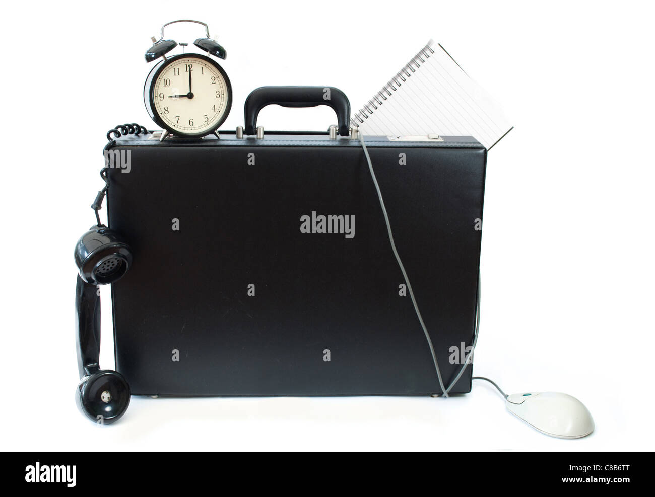 Various office appliances hanging out of a briefcase including a