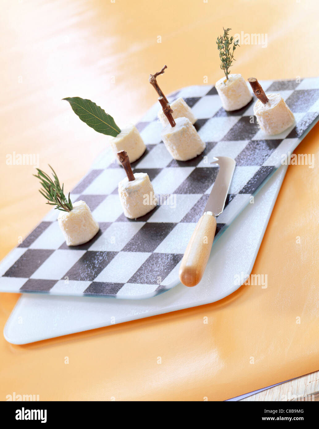 mini goat's cheeses on chessboard cheese platter Stock Photo Alamy