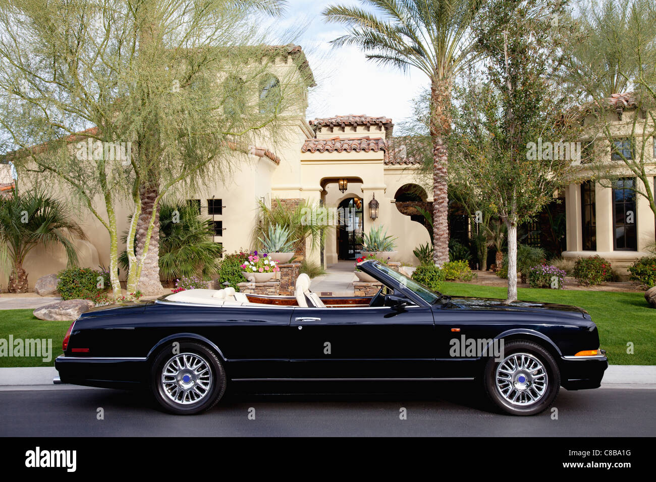 Side view of a open roof car in front of villa Stock Photo Alamy