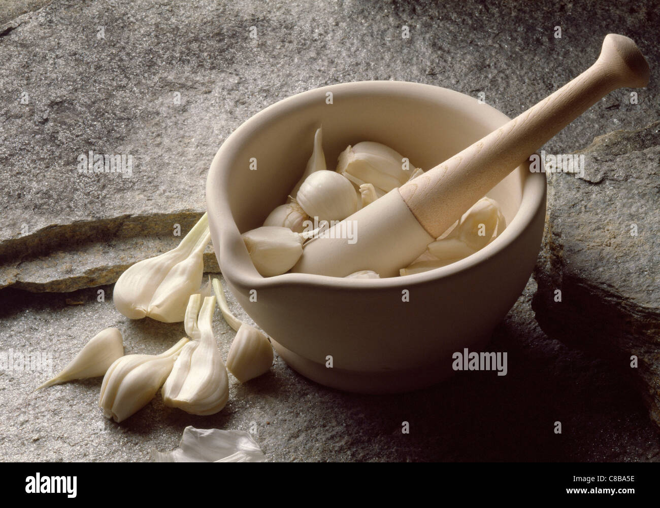 crushing garlic with pestle and mortar Stock Photo Alamy