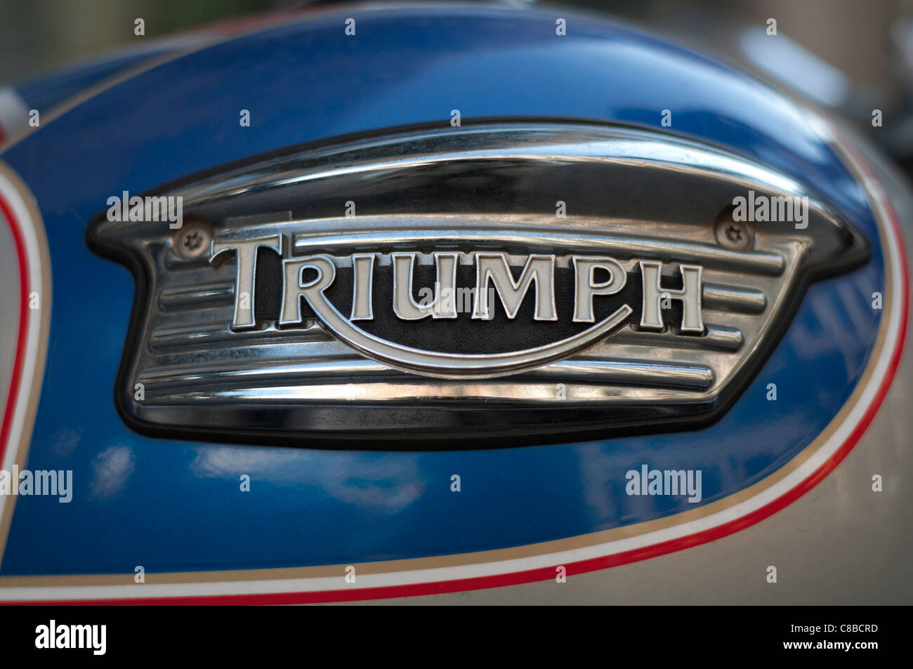 Triumph metal logo on motorcycle fuel tank, shallow DOF Stock Photo