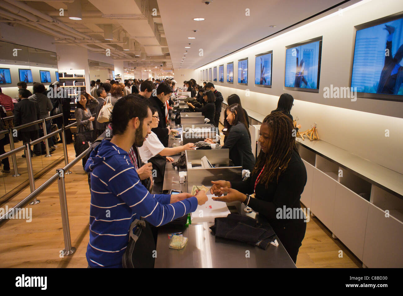 Customers shop at the grand opening of the Uniqlo Flagship store on Fifth  Avenue in New York Stock Photo - Alamy