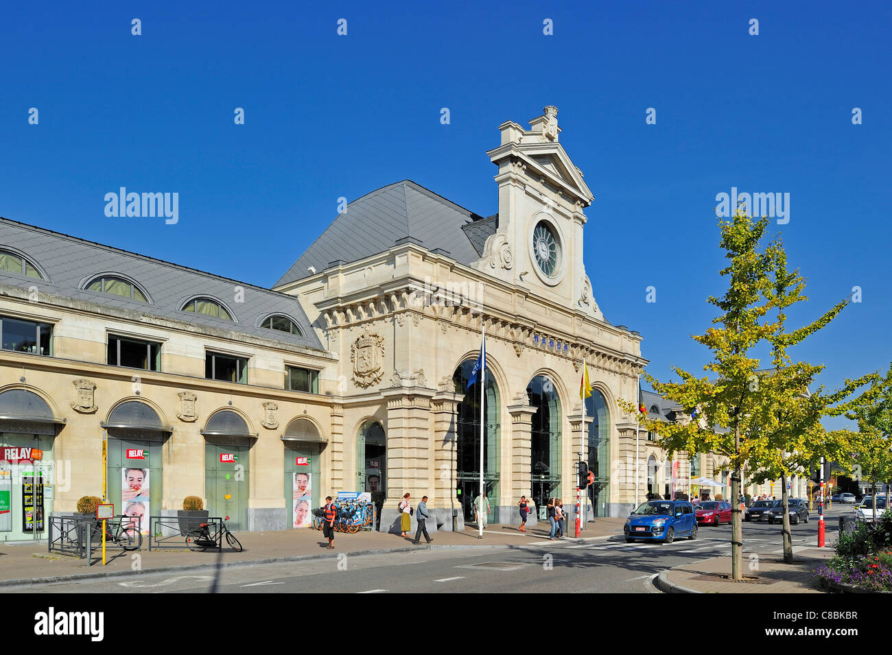 Commuters crossing street in front of the entrance of the railway station Gare de Namur, Belgium Stock Photo