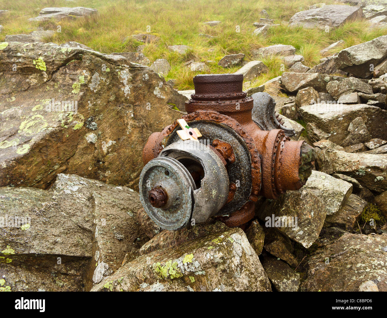 Wartime remains of propeller hub with remembrance cross & poppy from a Halifax bomber crash on Great Carrs, Cumbria.. Stock Photo