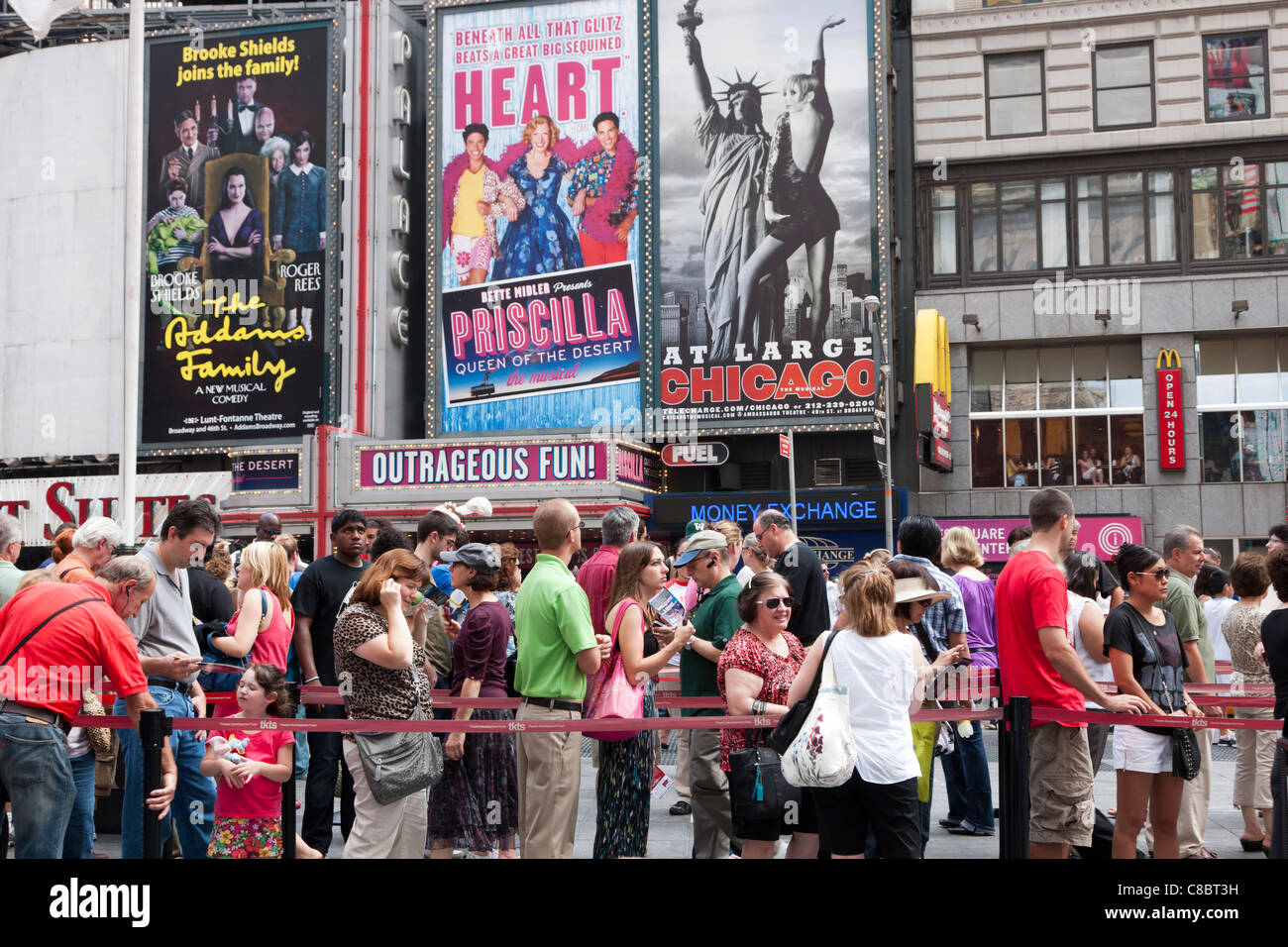 People stand in line to purchase discount theater tickets at the TKTS booth in Duffy Square in Times Square, New York City. Stock Photo