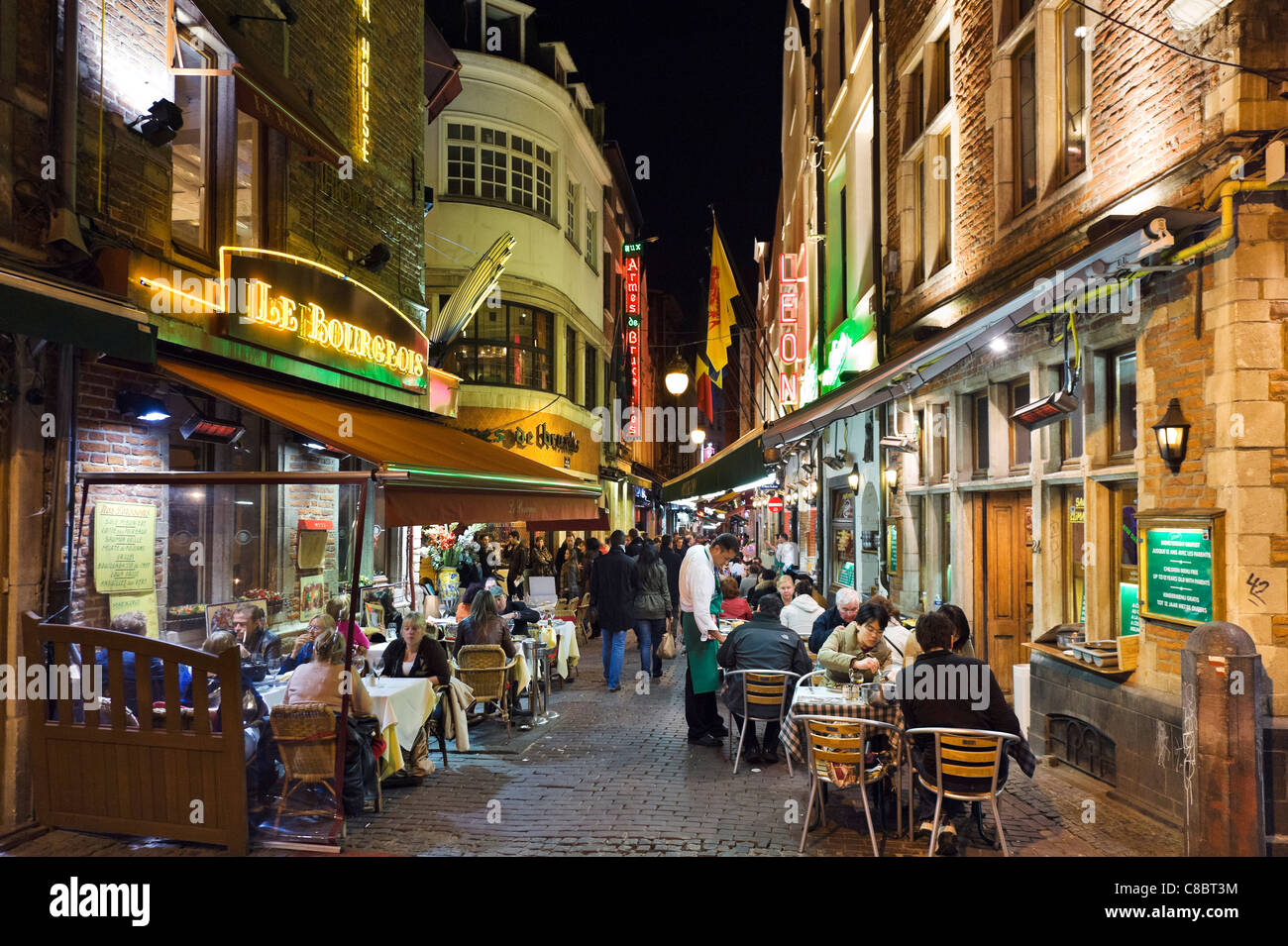 Restaurants at night on the Petite Rue des Bouchers, Brussels, Belgium Stock Photo