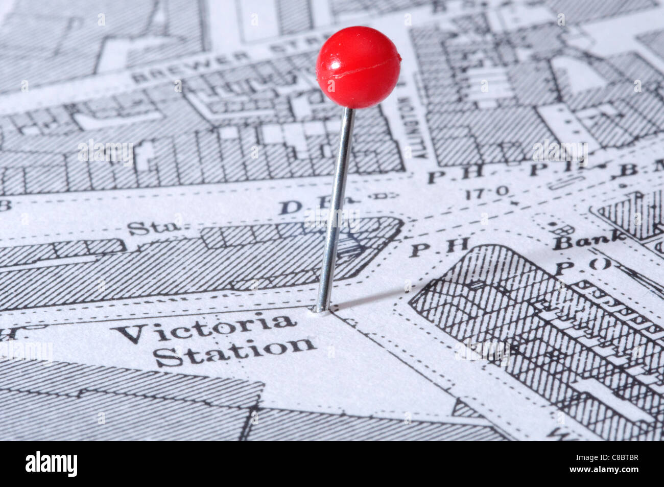 Victoria Station in London indicated using a map pin. Map is an out-of-copyright 1894 edition. Stock Photo