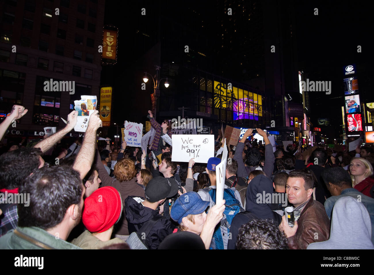 Thousands of Occupy Wall Street Protesters holding signs at night in New York City's Times Square on October 15th 2011 Stock Photo