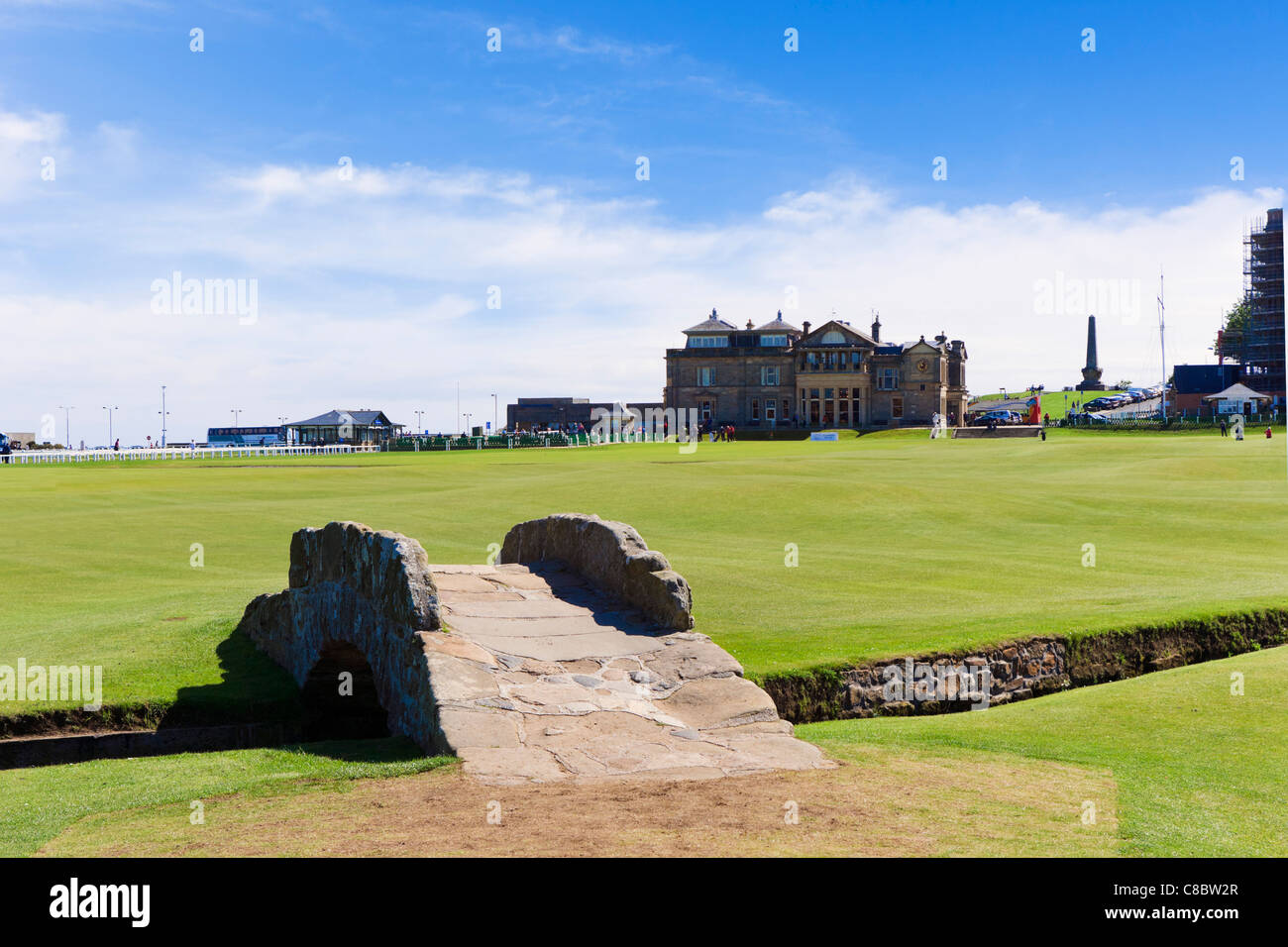 The Swilcan Bridge over the Swilcan Burn with the Royal and Ancient Clubhouse behind, Old Course at St Andrews, Fife, Scotland Stock Photo