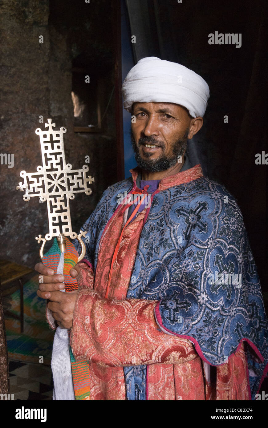 Priest in Bet Danaghel Church holding the Cross of King Lalibela. The  rock-hewn churches of Lalibela make it one of the greatest  Religio-Historical sites not only in Africa but in the Christian