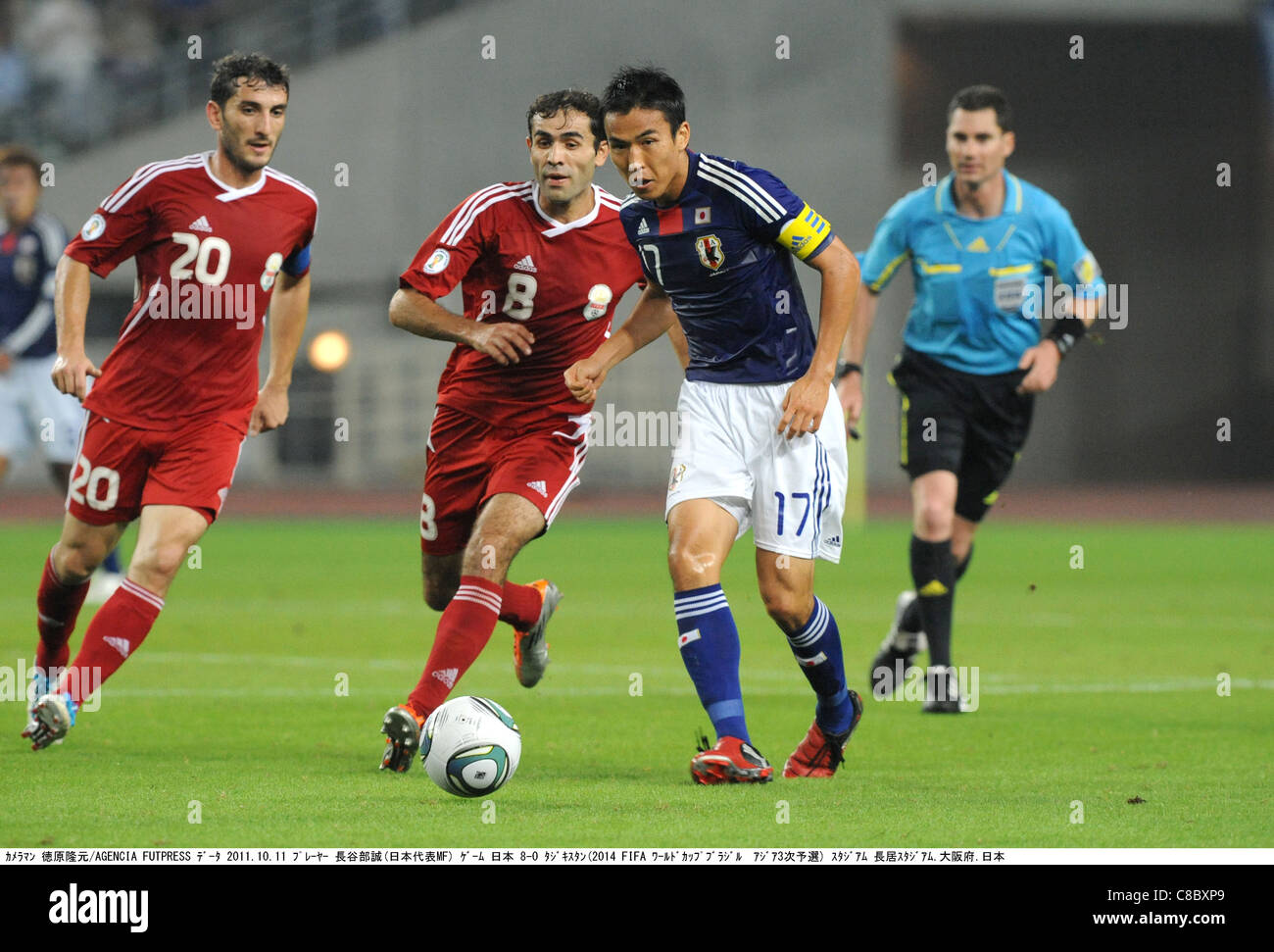 Makoto Hasebe (JPN) and Makhmadali Sadykov play during the 2014 FIFA World Cup Asian Qualifiers : Japan 8-0 Tajikistan. Stock Photo