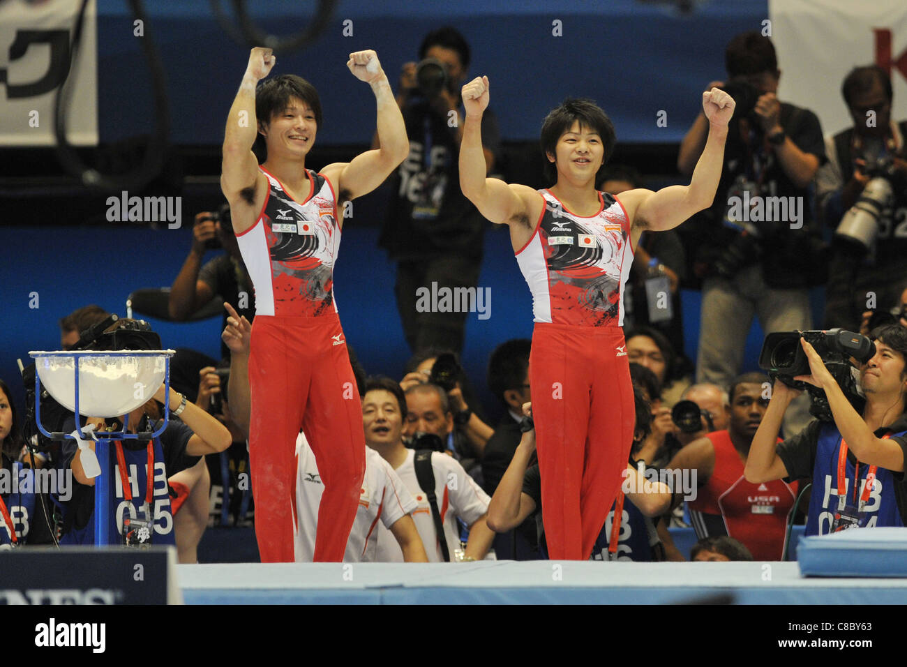 Kohei Uchimura and Koji Yamamuro (JPN) celebrate their victory of the 2011 World Artistic Gymnastics Championships in Japan. Stock Photo