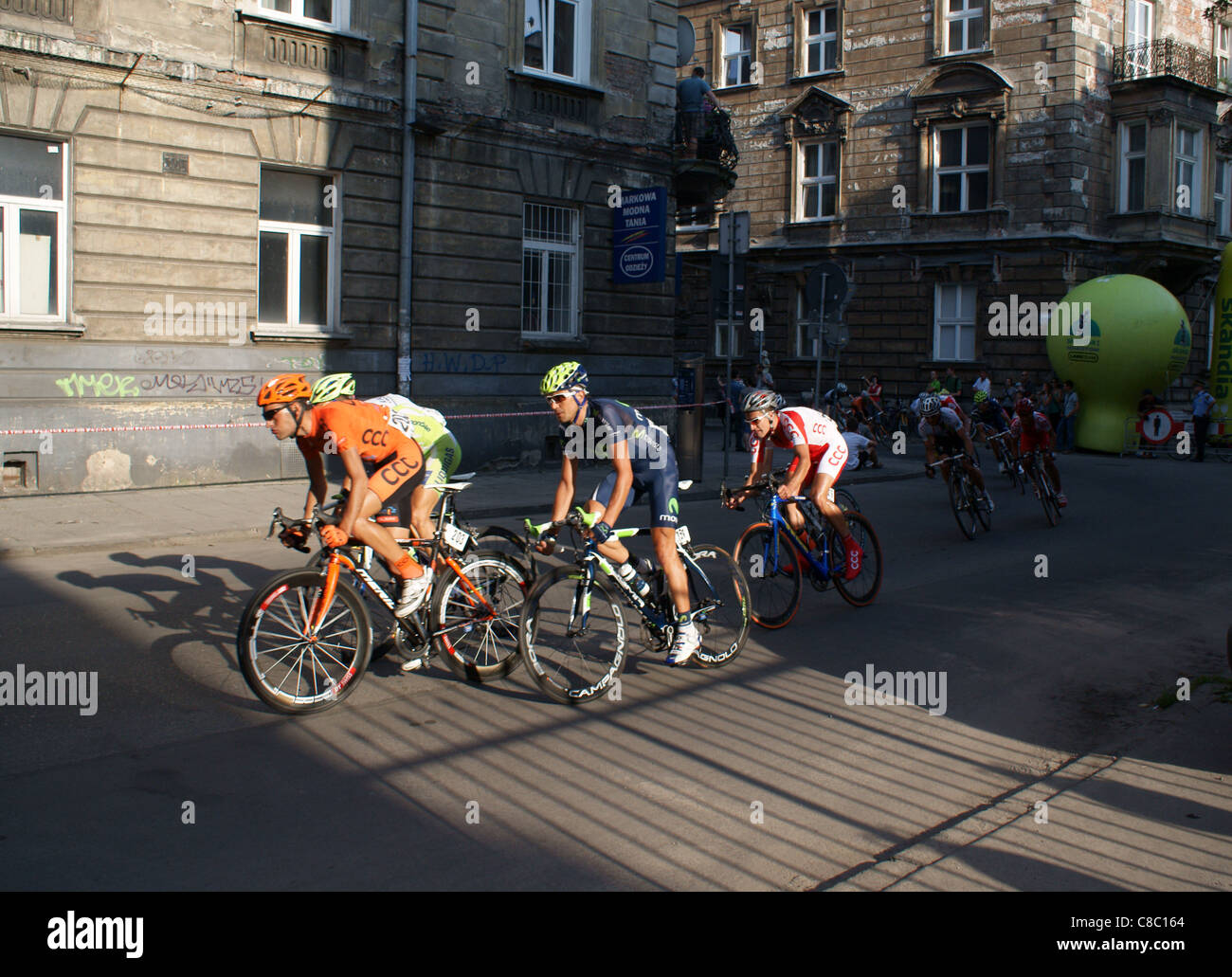 Cyclists riding in the narrow streets of Old City in Cracow during last stage of Tour de Pologne 2011 race. Stock Photo