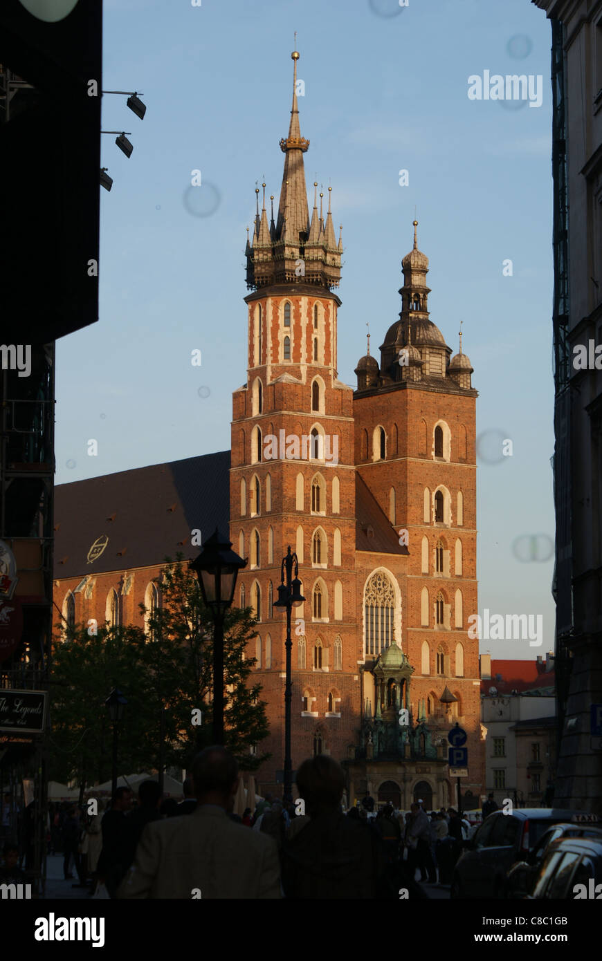 Mariacki Basillica, the most beautiful polish church lighted by sunset, is viewed from Szczepanska street  in Cracov, Poland. Stock Photo