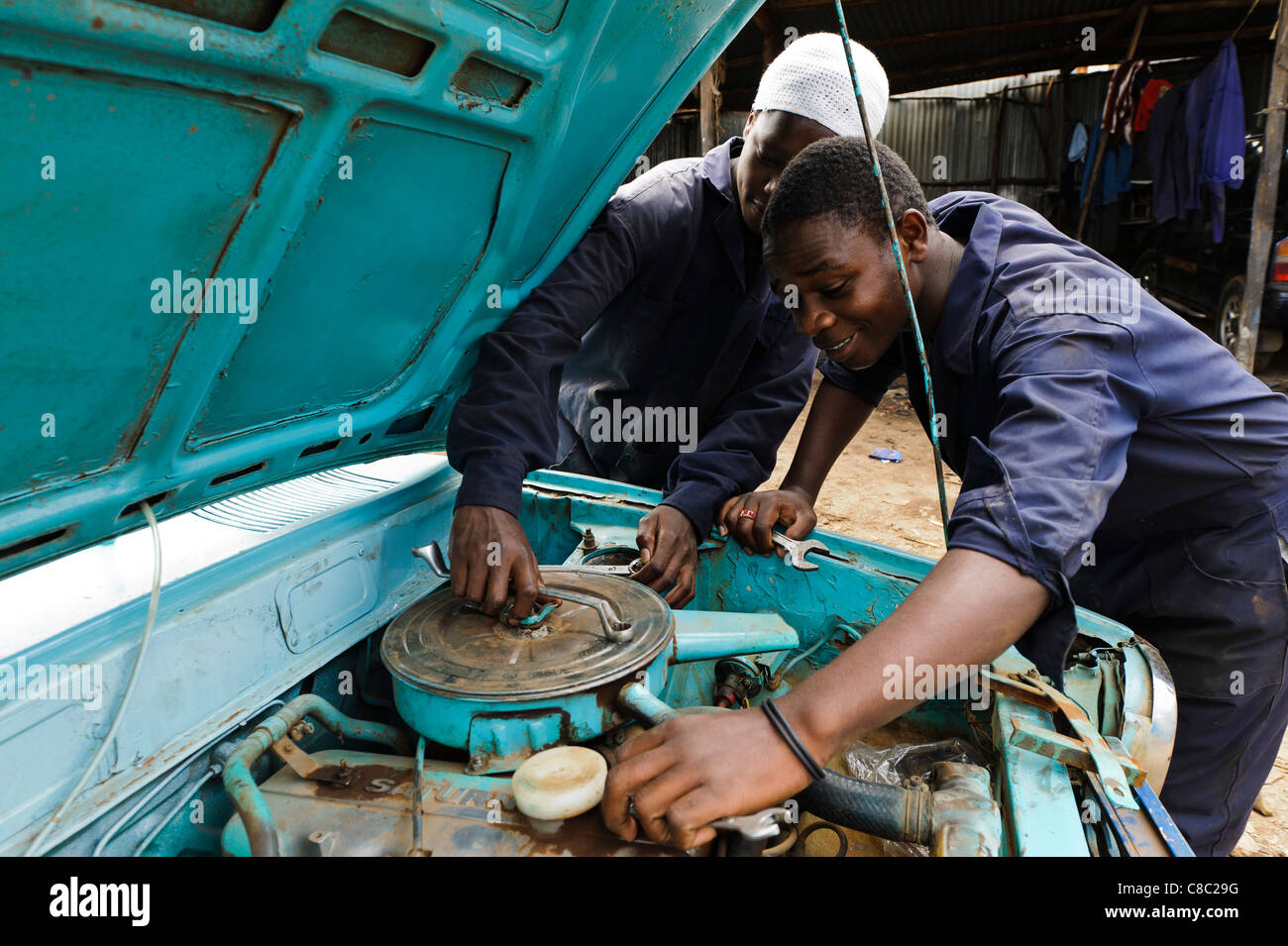 Trainee mechanics working on a car engine, Thika, Kenya Stock Photo Alamy