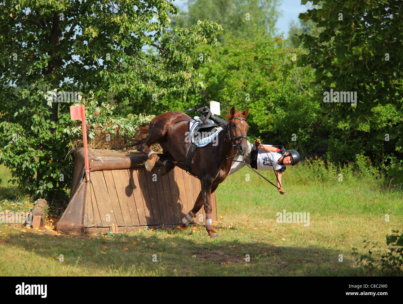 Horse rider about to fall off a horse during trial jumping Stock Photo Alamy