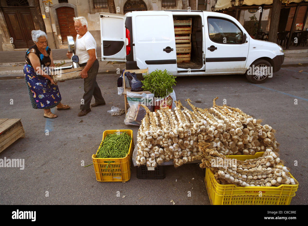 A couple set up their stall at the street market in Sulmona, Italy. Stock Photo