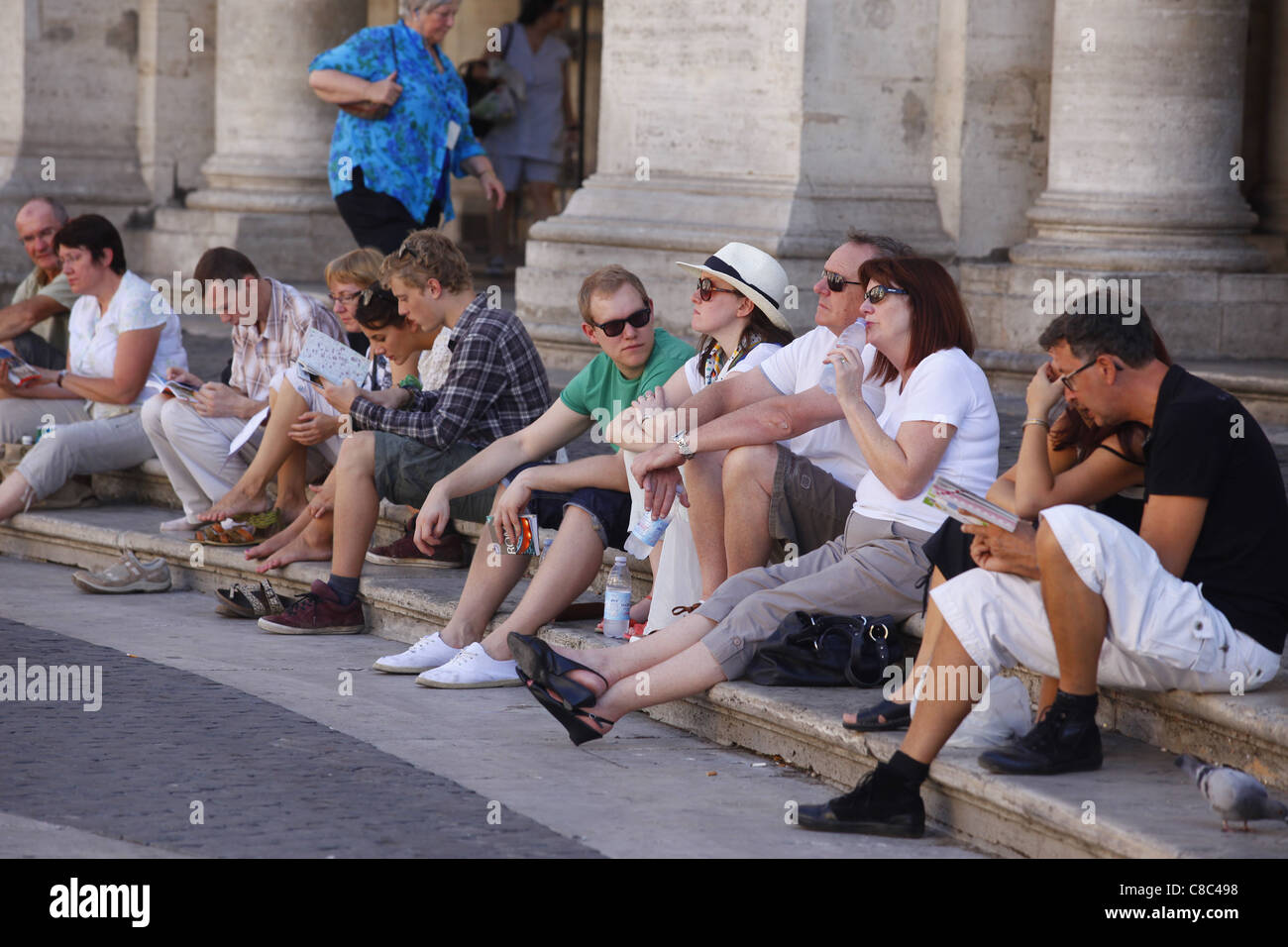 Tourists sat around the egde of the Piazza del Campidoglio in Rome, Italy. Stock Photo