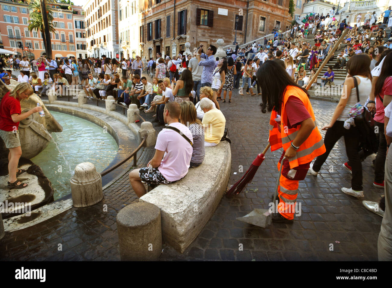 A street cleaner at work amongst the tourists on the Piazza di Spagna near the Spanish Steps in Rome, Italy. Stock Photo