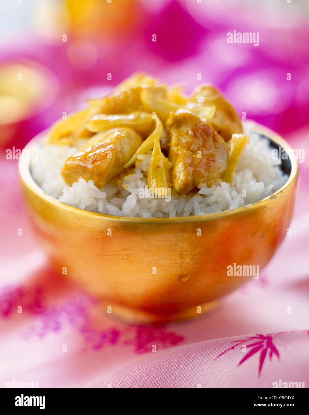 bowl of rice and sautéed curried chicken Stock Photo - Alamy